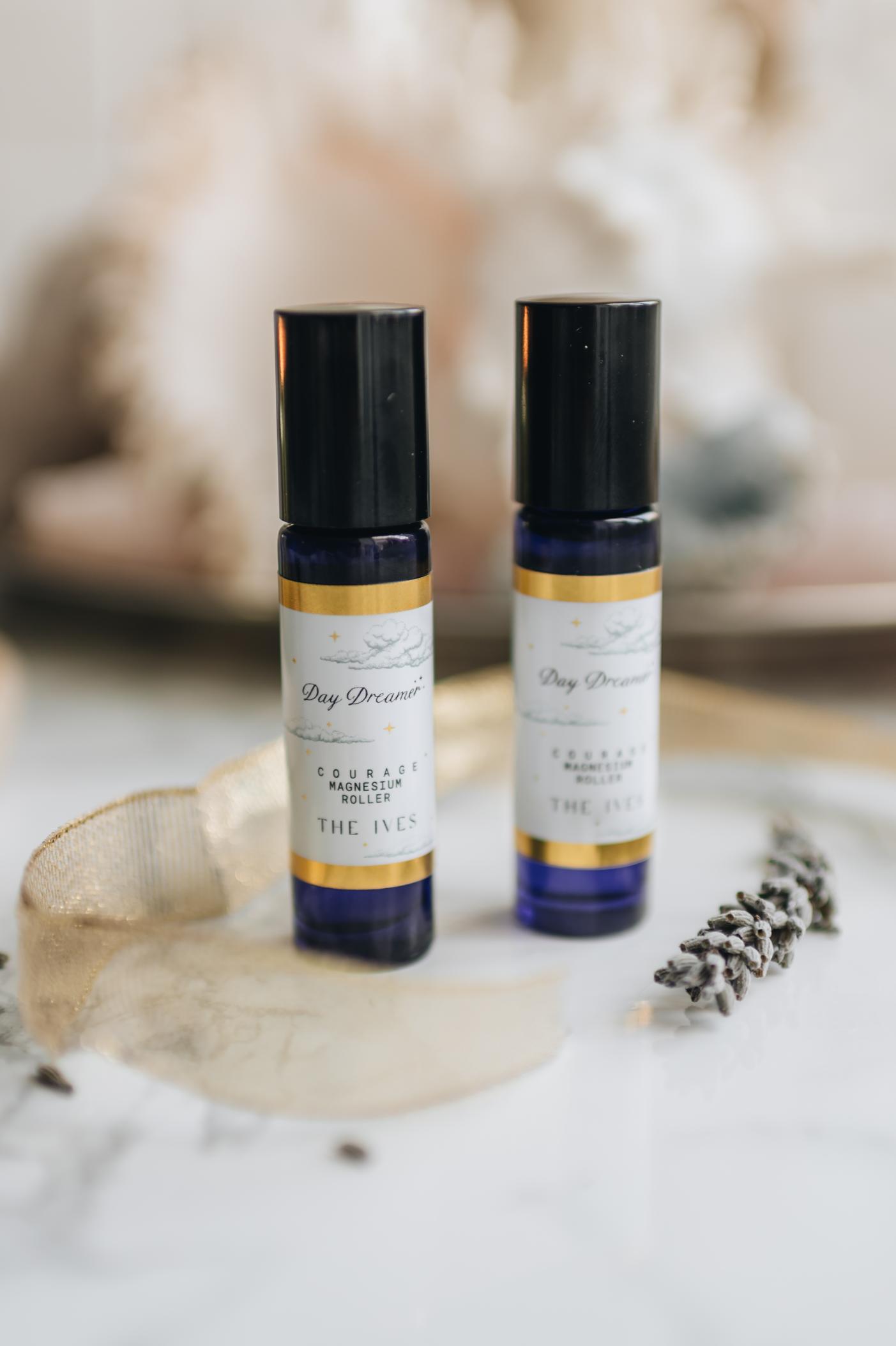 Magnesium oil anxiety relief essential oil roller, blue glass bottle with label of cloud and gold rim. lavender & vanilla or bergamot & Peppermint, pulse point rollers for courage when anxiety relief is needed. Stress relief product natural, handmade UK vegans